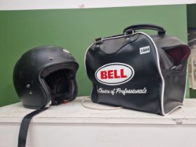 A BELL CRASH HELMET, APPEARS UNUSED C/W BELL CARRY BAG.