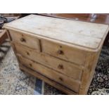 A VICTORIAN PINE CHEST OF TWO SHORT AND TWO LONG DRAWERS ON PAD FEET