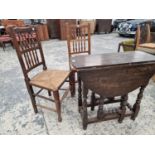 AN OAK OVAL FLAP TOP OCCASIONAL TABLE TOGETHER WITH TWO RUSH SEATED CHAIRS