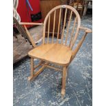 A CONTEMPORARY ERCOL TEAK ROUND ARCH STICK BACK ROCKING CHAIR WITH CURVED ARMS