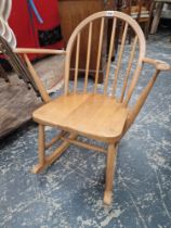 A CONTEMPORARY ERCOL TEAK ROUND ARCH STICK BACK ROCKING CHAIR WITH CURVED ARMS