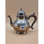 A SILVER TEA POT ASSAYED RWB FOR THE CHAIRMAN OF HARRODS, LONDON 1934, THE BLAUSTER FORM WITH A
