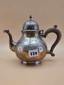 A SILVER TEA POT ASSAYED RWB FOR THE CHAIRMAN OF HARRODS, LONDON 1934, THE BLAUSTER FORM WITH A