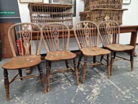A SET OF FOUR WHEEL BACKED WINDSOR CHAIRS