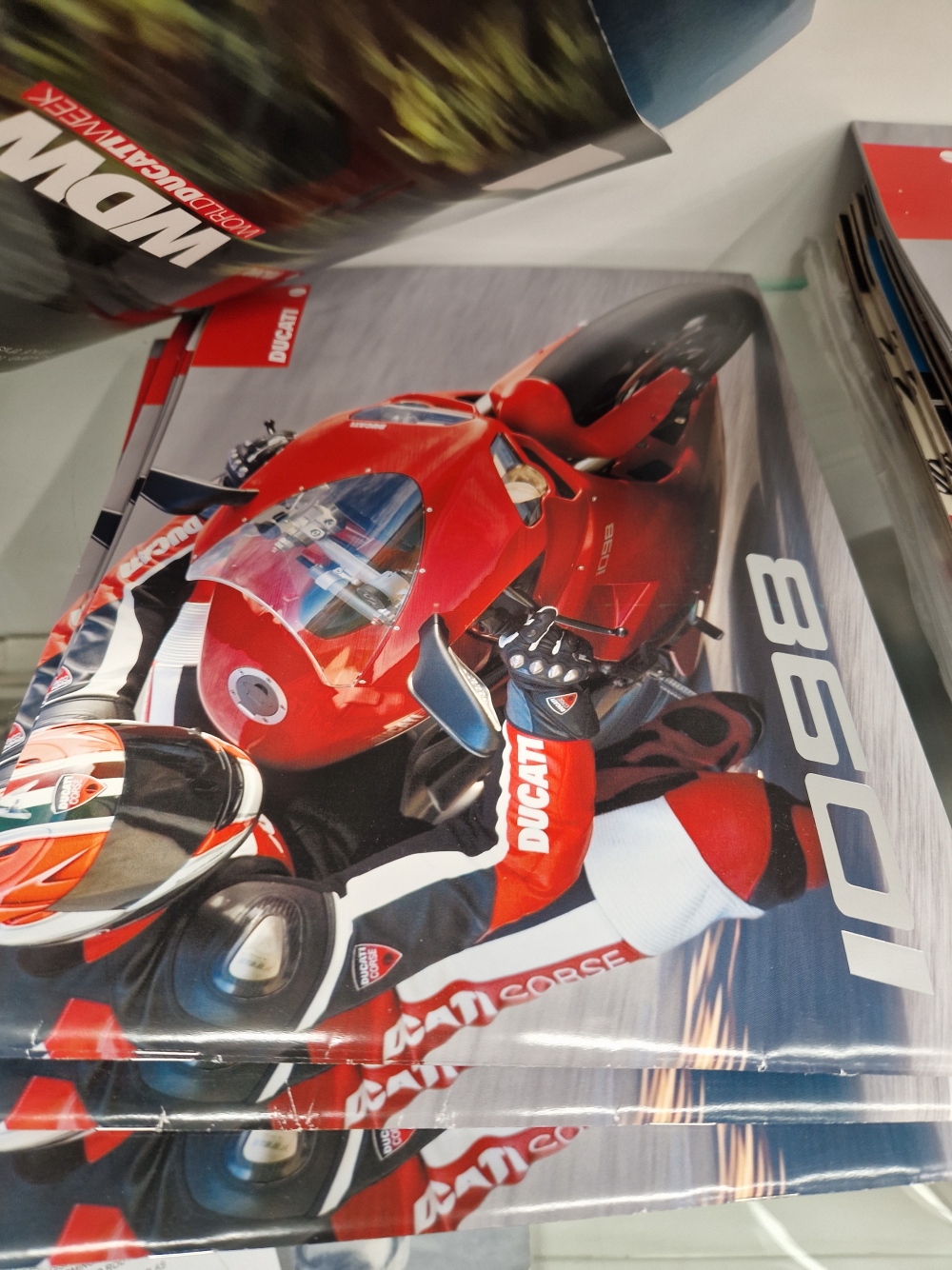 A BOX CONTAINING VARIOUS DUCATI AND OTHER MOTORCYCLE BROCHURES AND RELATED EPHEMERA.