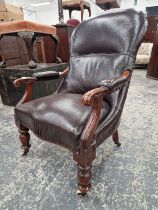 A VICTORIAN MAHOGANY ARMCHAIR UPHOLSTERED IN BROWN, THE BOBBIN TURNED FRONT LEGS ON CASTER FEET