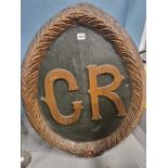 TWO PAINTED WOOD AND GESSO OVAL PANELS, ONE WITH THE RAISED INITIALS G R AND THE OTHER WITH THE