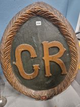 TWO PAINTED WOOD AND GESSO OVAL PANELS, ONE WITH THE RAISED INITIALS G R AND THE OTHER WITH THE