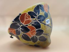 AN ART DECO GLASS CEILING BOWL PAINTED WITH BLACK LEAVES AND ORANGE ROSES, INDISTINCTLY SIGNED