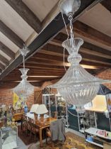 A PAIR OF FLUTED CLEAR GLASS CEILING LIGHTS, THE LIGHT SOCKETS SHADED BY CIRCULAR HOODS AND ABOVE