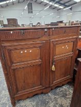 A 19th C. FRENCH WALNUT CABINET WITH TWO FLUTE FRONTED DRAWERS ABOVE TWIN PANELLED DOORS AND A