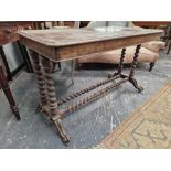 A VICTORIAN WALNUT SIDE TABLE WITH PAIRS OF BARLEY TWIST COLUMNS TO EACH NARROW END ON SCROLL LEGS