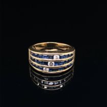 A SAPPHIRE AND DIAMOND THREE ROW CHANNEL SET HALF HOOP RING. UNHALLMARKED, ASSESSED AS 18ct GOLD.