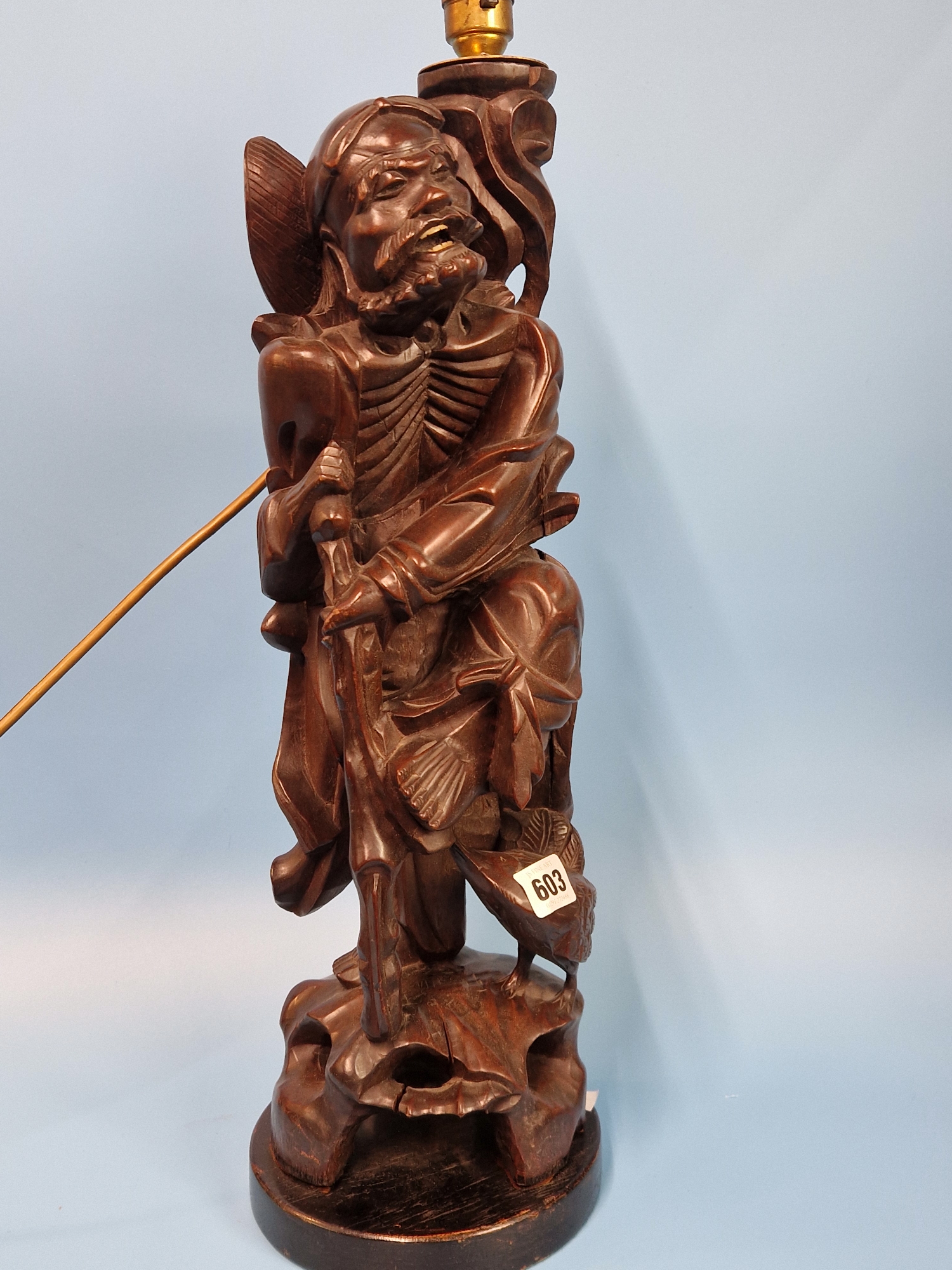 A CHINESE CARVED WOOD TABLE LAMP IN FORM OF THE DAOIST IMMORTAL LITIEGUAI. H 56cms.