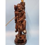 A CHINESE CARVED WOOD TABLE LAMP IN FORM OF THE DAOIST IMMORTAL LITIEGUAI. H 56cms.