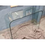 A VINTAGE CURVED GLASS CONSOLE TABLE.