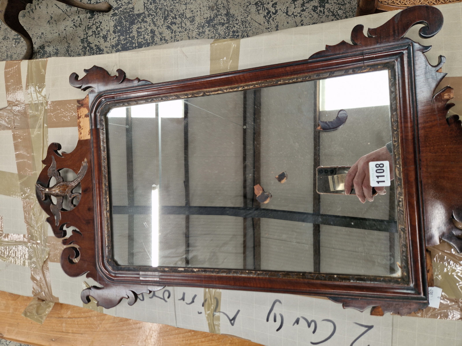 A FRET FRAMED WALL MIRROR.