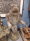 A WEATHERED COMPOSITE STONE FIGURE OF A BULLDOG STANDING IN THE DRESS OF A BUTLER WITH HIS