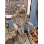 A WEATHERED COMPOSITE STONE FIGURE OF A BULLDOG STANDING IN THE DRESS OF A BUTLER WITH HIS