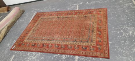 A MACHINE MADE CARPET OF FIGURAL TRIBAL DESIGN 300 x 202 cm