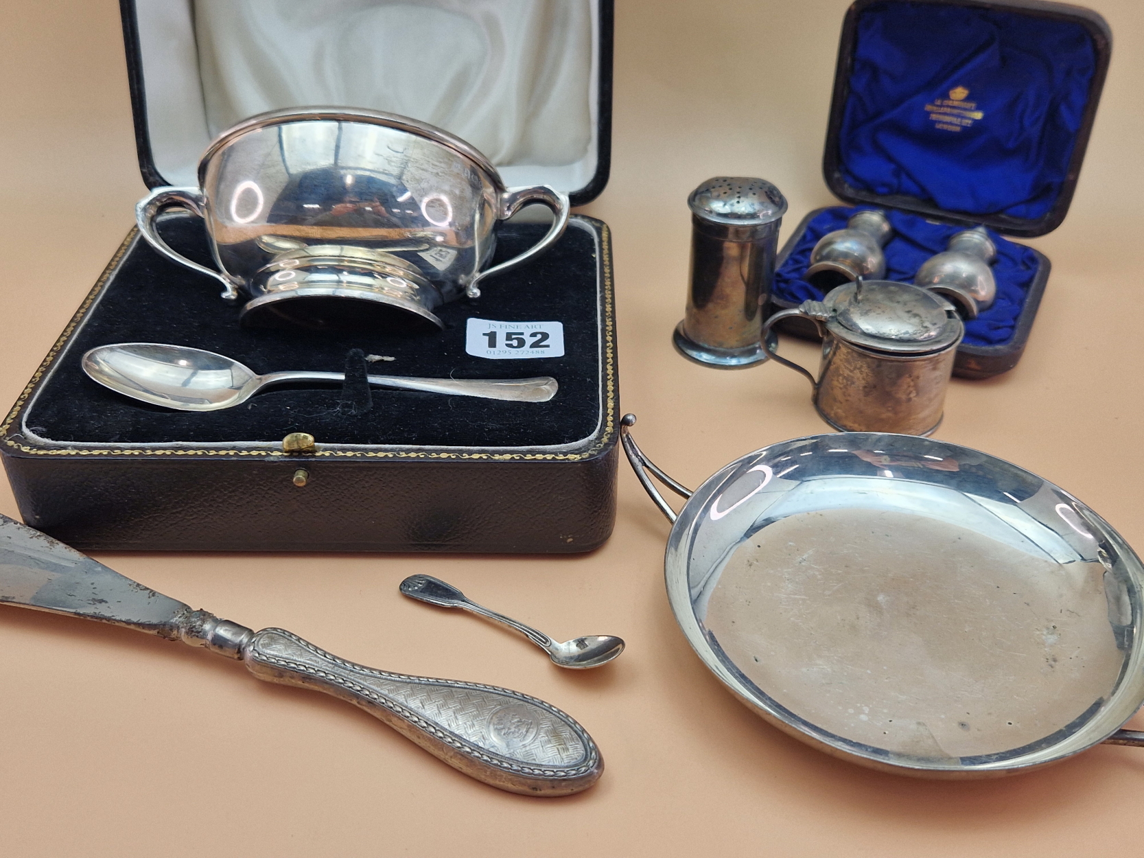 A HALLMARKED SILVER CASED TWO HANDLED BOWL AND SPOON SET, A SHALLOW TWO HANDLED DISH, CASED SALT AND