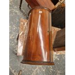 A MAHOGANY CORNER CUPBOARD WITH A QUARTER ROUND FRONTED DOOR