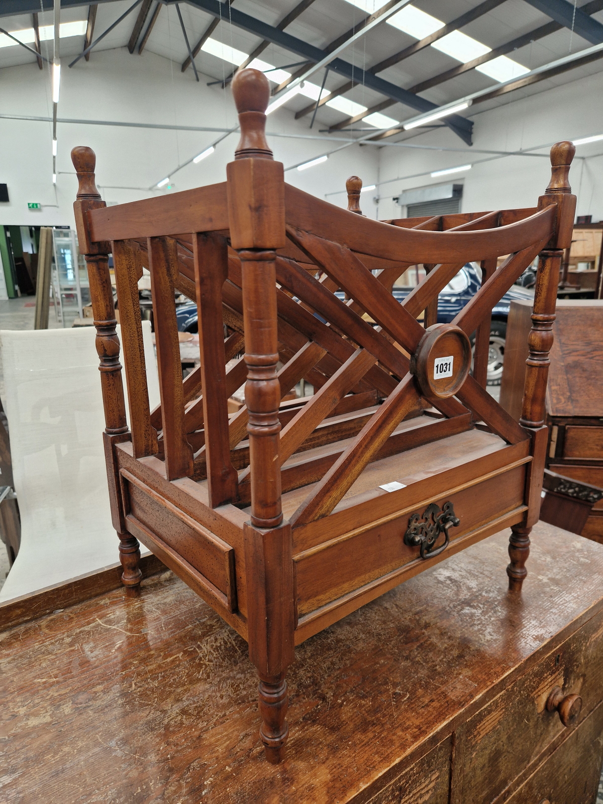 A CONTEMPORARY MAHOGANY CANTERBURY WITH A DRAWER BELOW THE FOUR COMPARTMENTS