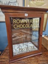 A GLAZED MAHOGANY COUNTER TOPPED CABINET WITH TWO GLASS SHELVES, THE DOOR INSCRIBED ROWNTREES