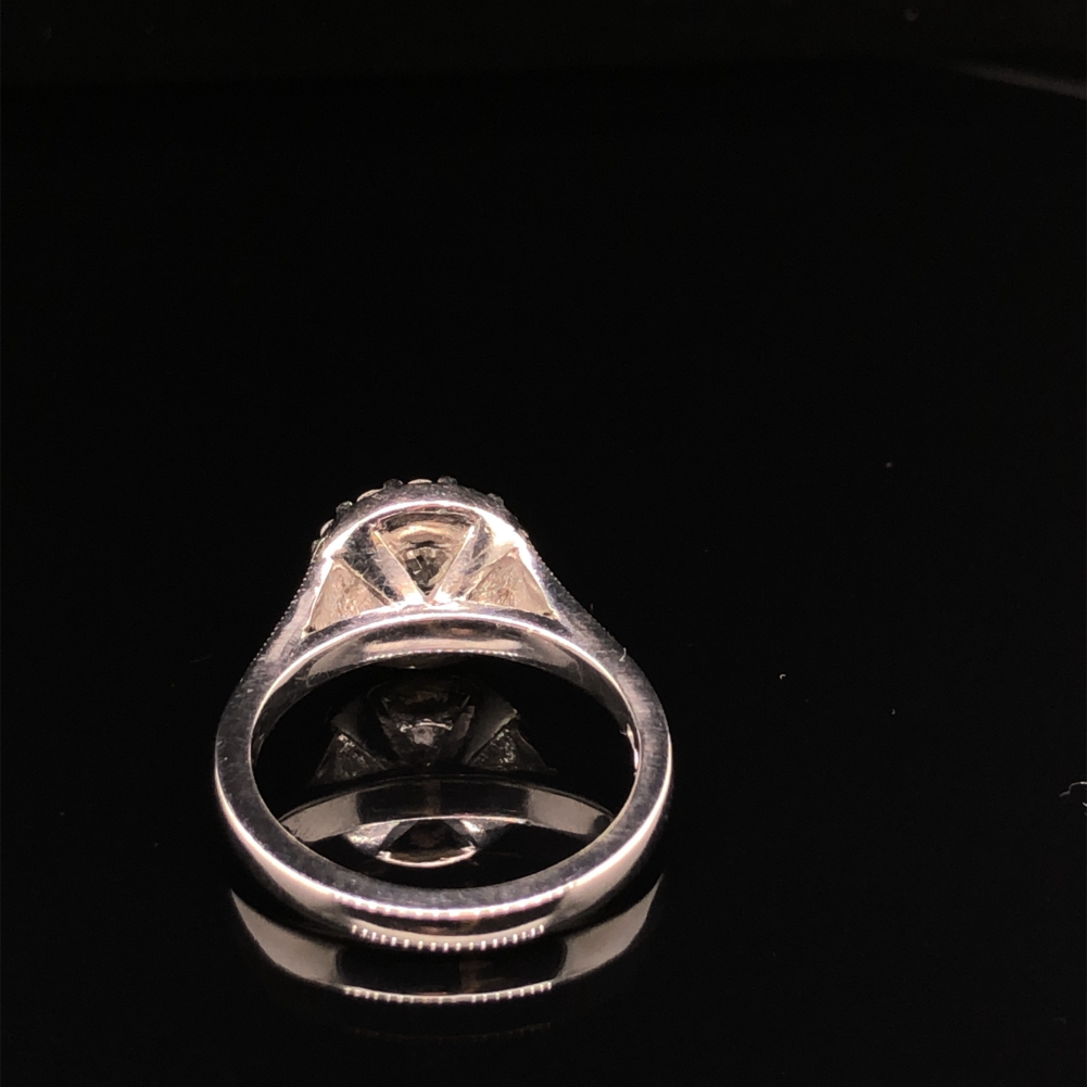 A GIA ROUND BRILLIANT CUT DIAMOND AND PLATINUM RING. THE CENTRE DIAMOND 0.71cts, SURROUNDED BY A - Image 6 of 10
