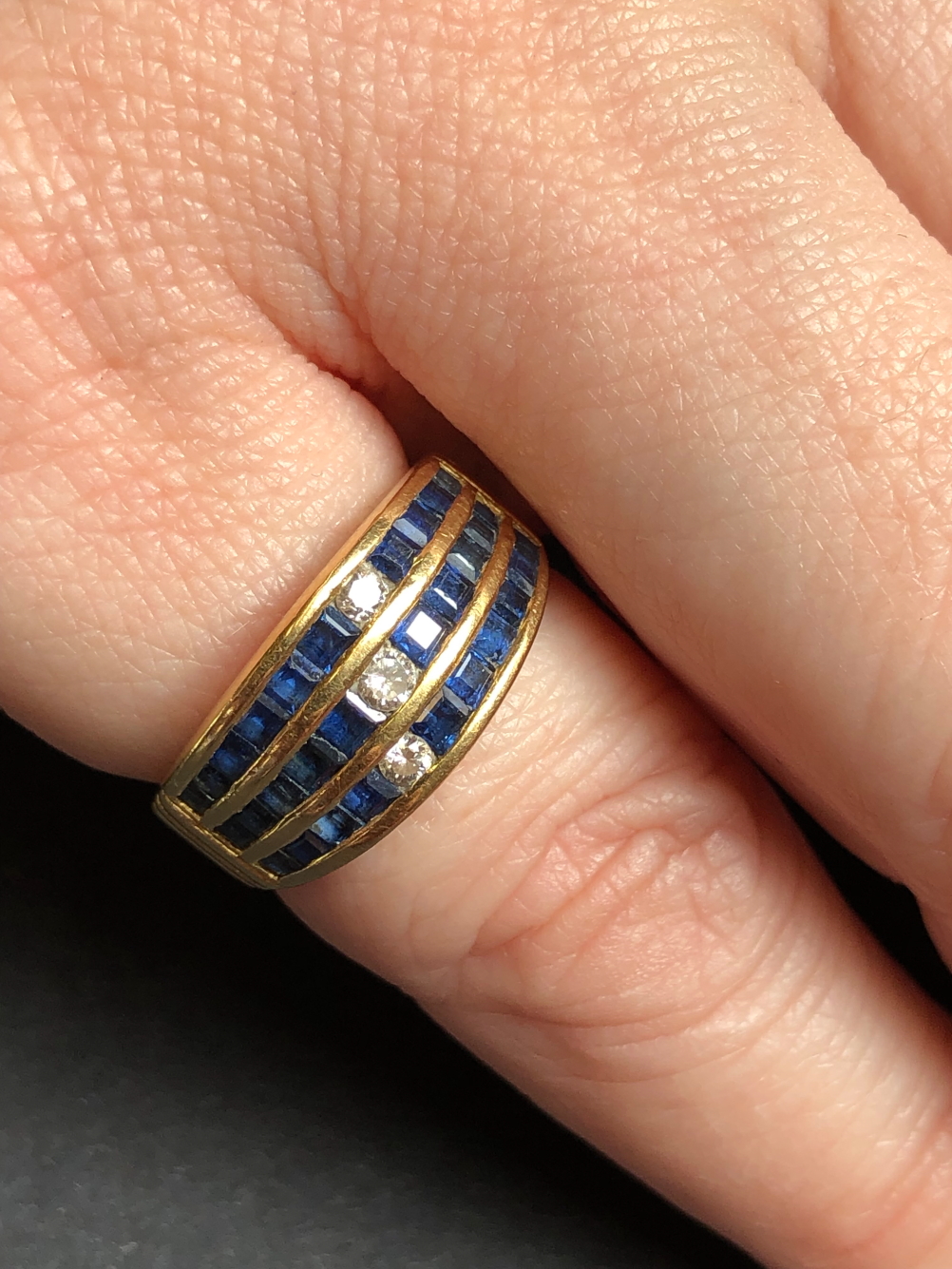 A SAPPHIRE AND DIAMOND THREE ROW CHANNEL SET HALF HOOP RING. UNHALLMARKED, ASSESSED AS 18ct GOLD. - Image 4 of 7