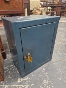 A STRONG BOX WITH A BLUE METALLIC FINISH AND KEYS TO THE DOOR