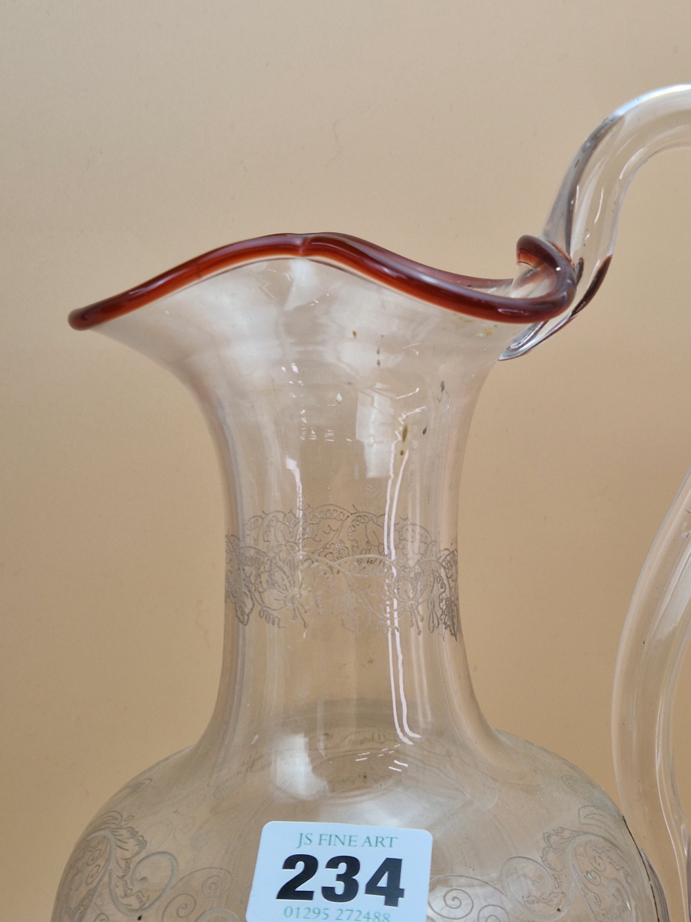 A CLEAR GLASS BALUSTER EWER ETCHED WITH CUPID OVALS AND WITH A CRANBERRY TRAILED RIM AND FOOT, A - Image 5 of 14