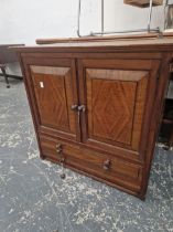 AN ARTS AND CRAFTS WALNUT SMALL CABINET WITH TWO DRAWER BELOW DOORS.