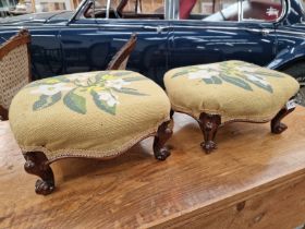 A PAIR OF ROSEWOOD FOOTSTOOLS WITH YELLOW GROUND FLORAL NEEDLE WORK SEATS