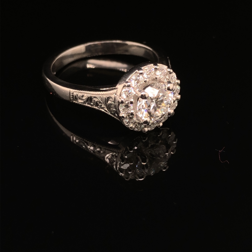 A GIA ROUND BRILLIANT CUT DIAMOND AND PLATINUM RING. THE CENTRE DIAMOND 0.71cts, SURROUNDED BY A - Image 2 of 10