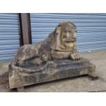 AN IMPRESSIVE PAIR OF RECONSTITUTED STONE ART DECO STYLISED RECUMBENT LIONS.