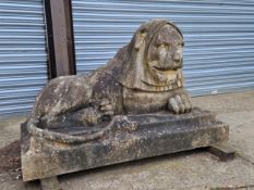 AN IMPRESSIVE PAIR OF RECONSTITUTED STONE ART DECO STYLISED RECUMBENT LIONS.
