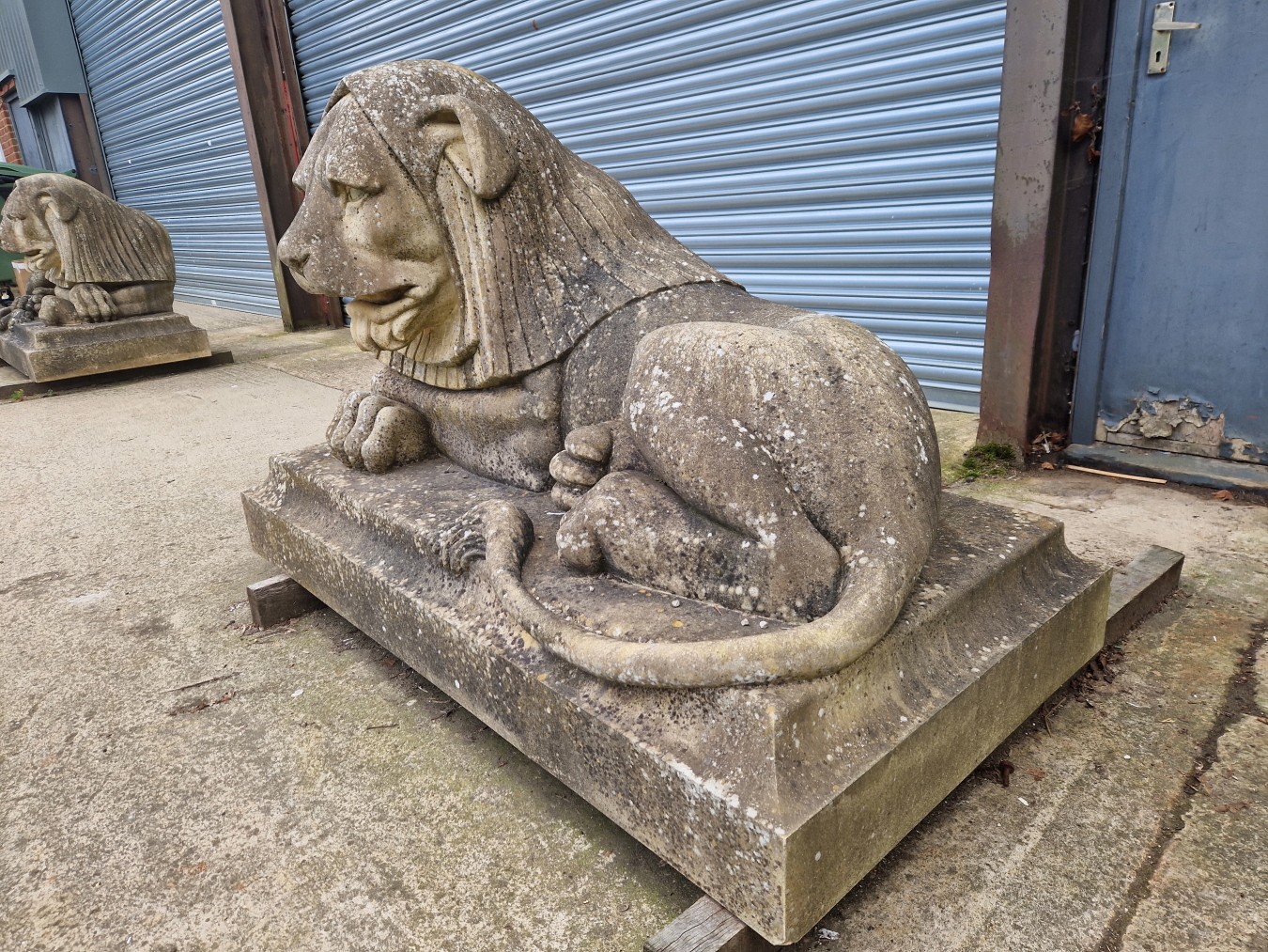 AN IMPRESSIVE PAIR OF RECONSTITUTED STONE ART DECO STYLISED RECUMBENT LIONS. - Image 3 of 13