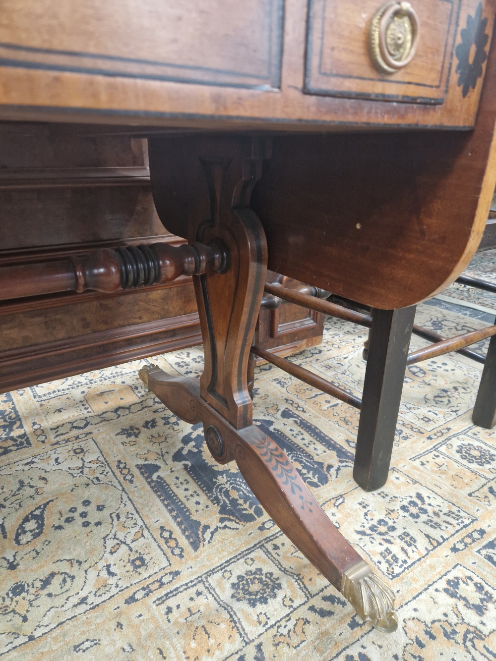 A MAHOGANY FLAP TOP GAMES TABLE DECORATED WITH AN EBONISED SCROLL BAND, THE CENTRE OF THE TOP - Image 6 of 7