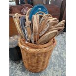 A NEST OF THREE CIRCULAR WOOD BASKETS FILLED WITH A COLLECTION OF TENNIS RACKETS