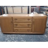 AN ERCOL PALE ELM LOW SIDEBOARD.