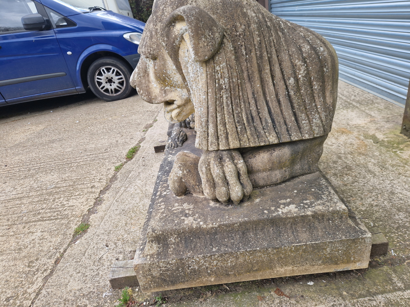 AN IMPRESSIVE PAIR OF RECONSTITUTED STONE ART DECO STYLISED RECUMBENT LIONS. - Image 12 of 13