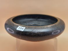A CHINESE BLACK CLOISONNE SHALLOW BOWL, THE INTERIOR WORKED WITH A DRAGON AND FLAMING PEARL. Dia.