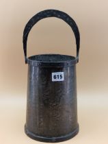 AN ARTS AND CRAFTS HAMMERED SHEET METAL PAIL, THE COPPER BANDED RIM FIXED WITH A HORSE SHOE SHAPED