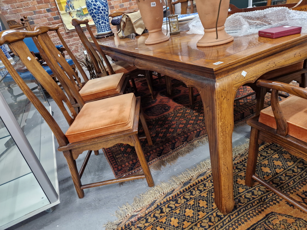A CHINESE ELM DINING TABLE TOGETHER WITH EIGHT CHAIRS TO INCLUDE TWO WITH ARMS, THE TABLE WITH TWO