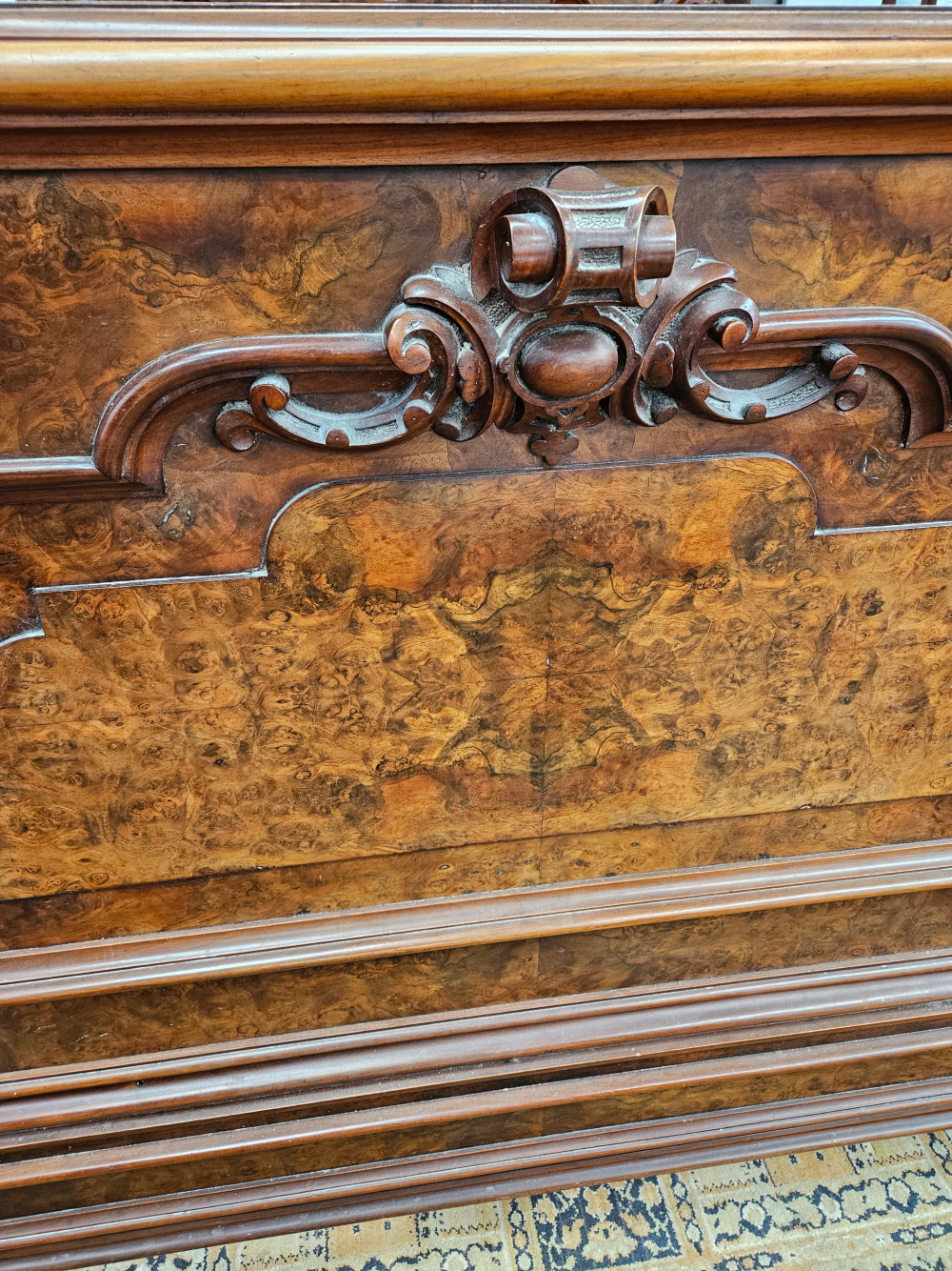 A LATE VICTORIAN BURR WALNUT DOUBLE BED WITH PANELLED ENDS FLANKED BY SCROLLING BRACKETS CARVED WITH - Image 6 of 8