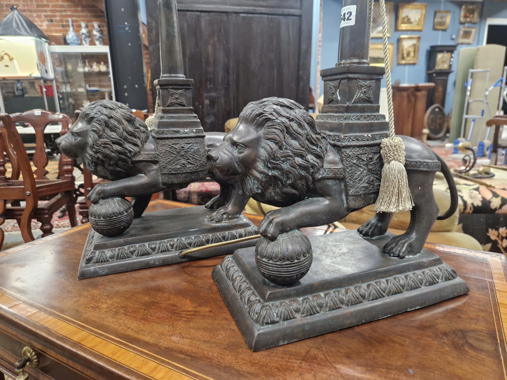 A PAIR OF BRONZE LION TABLE LAMPS, EACH STANDING WITH A FOREPAW RAISED ON A BROCADE BALL, THE - Image 2 of 3