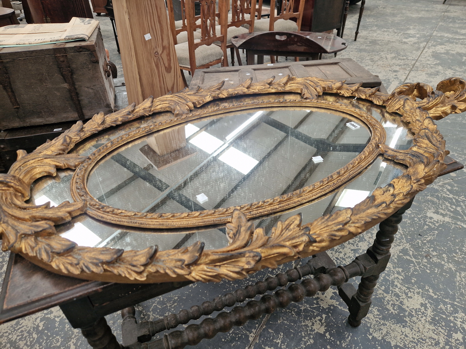 AN OVAL MIRROR WITHIN A FOLIATE GILT FRAME. 130 x 71cms. - Image 5 of 5