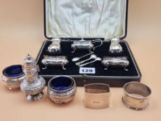 A CASED SILVER FIVE PIECE CRUET SET, A PAIR OF SILVER TUB SALTS, A BALUSTER PEPPER AND TWO SILVER