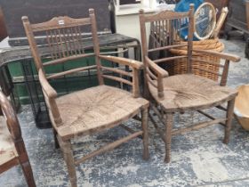 TWO WILLIAM MORRIS STYLE OAK ELBOW CHAIRS WITH RUSH SEATS